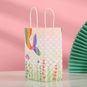 Detailed view of mermaid scale paper gift bag with turquoise shell and sturdy paper handle