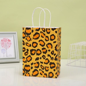 Yellow kraft paper gift bag with leopard print design and white twisted rope handles