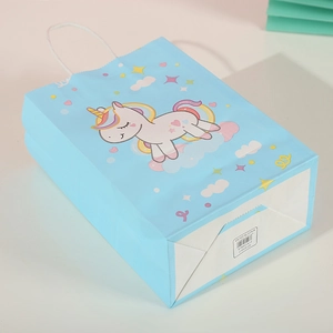 Detail view of unicorn kraft paper gift bag showing 21x15x8cm size and blue print