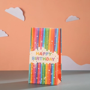 Rainbow striped kraft paper gift bag with Happy Birthday text for party favors