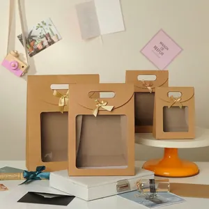 Brown kraft paper gift bags with clear window and gold ribbon bows in four sizes