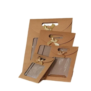 Brown kraft paper gift bags with clear window, die-cut handles, and golden satin bows