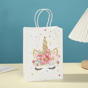 White kraft paper unicorn gift bag with floral crown and gold glitter horn accents