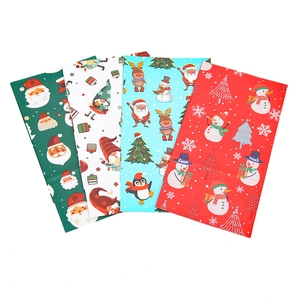 Set of four colorful Christmas kraft paper gift bags featuring festive cartoon prints