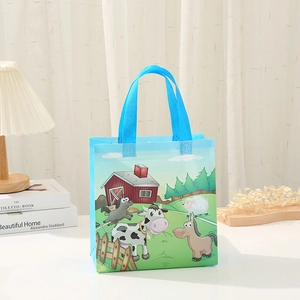 Detail of blue non-woven farm animal gift bag with cow and horse cartoon print