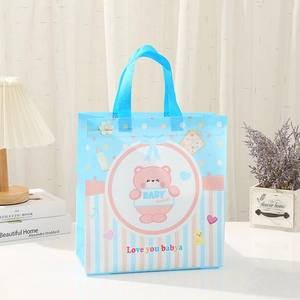Detail of baby shower non-woven gift bag with blue teddy bear print and stripe base
