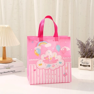 Pink striped non-woven gift bag with rainbow prints and Welcome Baby text for baby showers