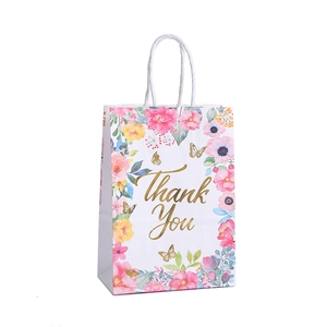 Sac cadeau blanc en papier avec motif floral, texte doré Thank You et poignées tressées