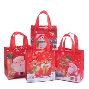 Red Christmas non-woven gift bags with festive prints of Santa Claus and Reindeer