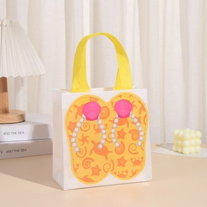Detail of white non-woven tote bag with yellow flip-flop print and woven handles