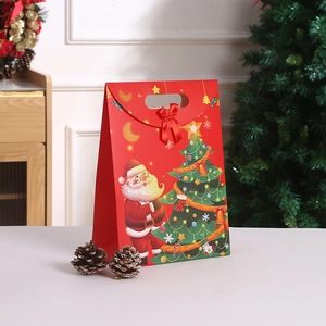 Christmas kraft paper gift bag with red bow and Santa illustration handheld carrier
