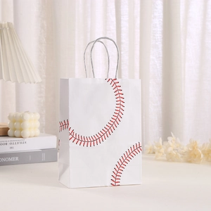 Baseball pattern kraft paper gift bag with white twisted rope handles in a cozy home setting