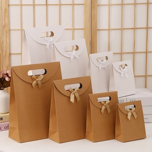 Bow-tied kraft paper gift bags in four sizes showing white and brown color options