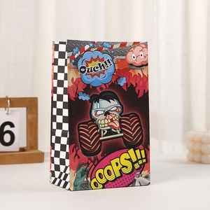 Close-up of paper gift bag with zombie monster truck print and racing flag pattern