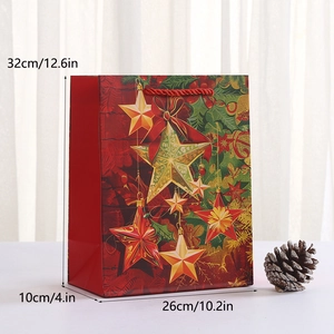 Detailed view of red Christmas paper bag with gold stars and dimensions 32x26x10 cm