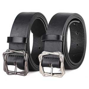Close-up of black leather belts showing textured litchi grain and unique metal buckles