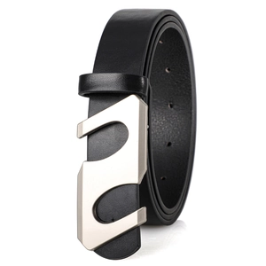 Detail of a thin black leather belt featuring a matte silver S-shaped buckle and metal holes
