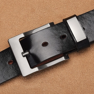 Detail of black business belt featuring lychee texture leather and brushed gunmetal buckle