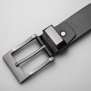 Close-up of men's business belt with brushed gunmetal buckle and black leather texture