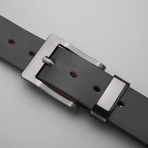 Detailed close-up of a men's vintage black leather belt with a brushed metal square buckle