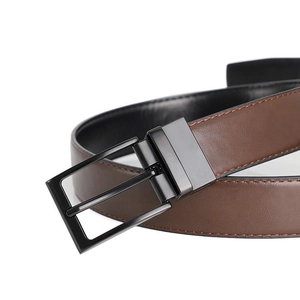 Close-up of matte black metal pin buckle and dual-sided brown and black leather belt