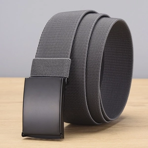 Detail of grey elastic woven belt with a matte black smooth buckle on wood surface