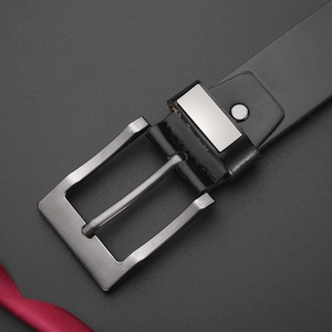 Close-up of brushed metal buckle on a classic black leather belt for men