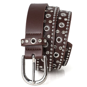 Close-up of punk style leather belt featuring silver rivets and sparkling rhinestones