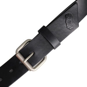 Detail of black leather belt with silver pin buckle and embossed Gluck logo patch