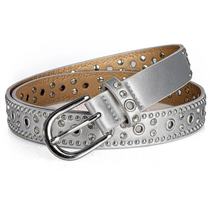 Detail of silver punk belt featuring metallic eyelets and sparkling rhinestones inlay