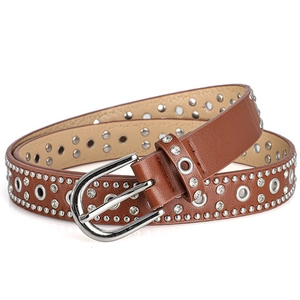 Macro detail of brown punk belt showing silver rivets and white zircon stones