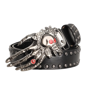 Close-up of gothic black studded belt featuring a silver skull and skeleton hand buckle