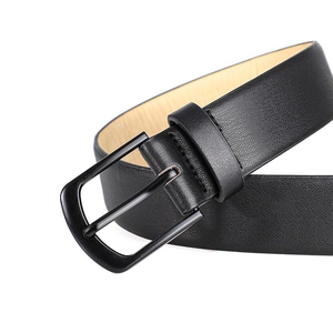 Detail shot of black leather belt with matte metal pin buckle and lychee texture