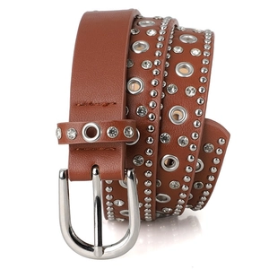 Detail of brown punk leather belt with silver rivets, rhinestones and horseshoe buckle