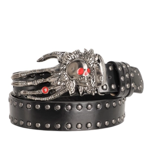 Close-up of gothic skull buckle with red eyes and silver rivets on black leather belt