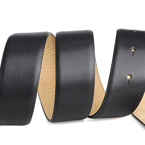 Detailed close-up of high-quality black leather belt with textured surface and adjustment holes