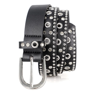 Close-up of punk black leather belt featuring silver rivets, eyelets and crystal rhinestones