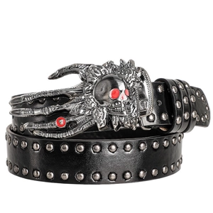 Detail of gothic skull buckle and silver rivets on black Y2K punk rock leather belt