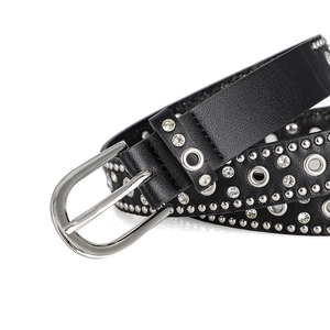 Detail of punk leather belt featuring silver studs, eyelets, and sparkling rhinestones