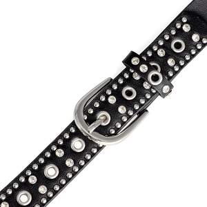 Detailed close-up of punk style black leather belt with silver studs and rhinestones
