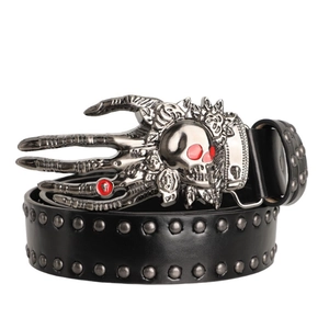 Detail of gothic skull buckle with red eyes and rose motifs on black studded leather belt