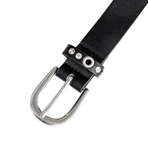 Detail of silver D-shaped metal buckle with white rhinestones on black leather belt