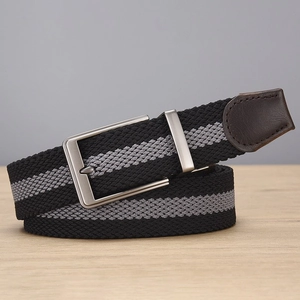 Macro view of woven elastic belt showing black grey stripe texture and leather end