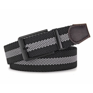 Detailed view of woven stretch golf belt with matte black buckle and leather tip finish