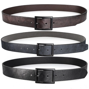 Close-up of retro PU leather belts with matte black metal buckles in three colors