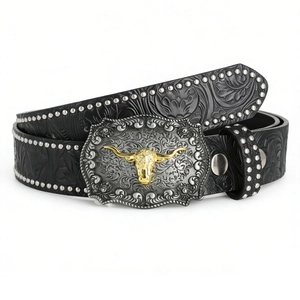 Close-up of western bull head buckle on black embossed leather belt with silver rivets