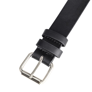 Detailed macro view of black leather belt with silver pin buckle and lychee texture grain