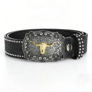 Detail of vintage belt featuring silver embossed buckle with golden bull head relief