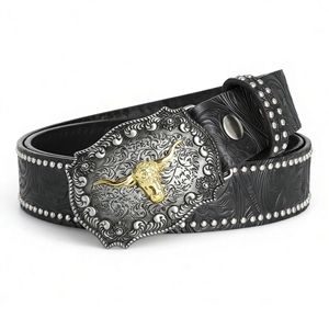 Detail of western cow head buckle with floral embossed leather and silver rivets