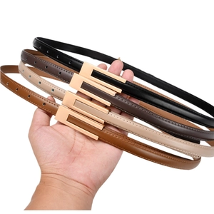 Detail of slim waist belts in black, brown, beige, and camel with gold buckles